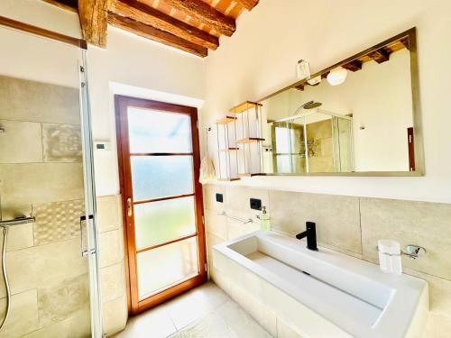 a bathroom with a sink and a mirror and a shower at TRUFFLE'N'BED in San Giovanni dʼAsso