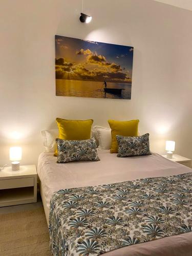 a bedroom with a bed with a painting on the wall at nulacaz in Rose Hill