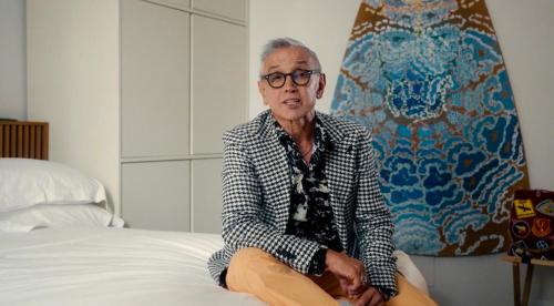an older man is sitting on a bed at Palazzo Italia Suites in Bari