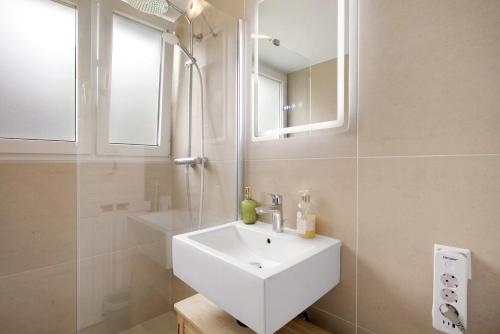 a white bathroom with a sink and a shower at Geschäftsreisetraum mit 6 Betten in Heidenheim