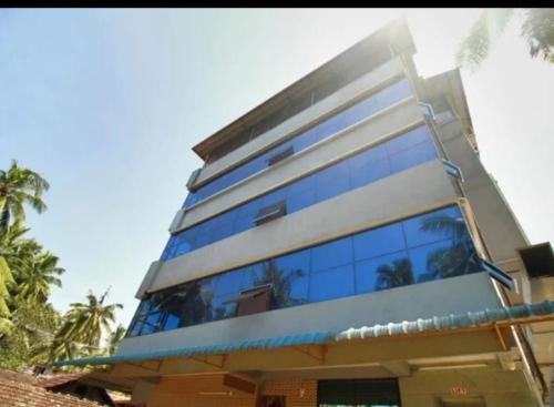 a building with a lot of windows on it at Hotel Kalyani International in Mūlki
