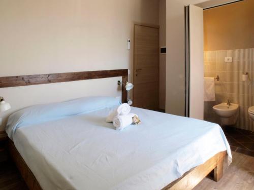 a bedroom with a bed with a towel on it at Agriturismo 30 in Moniga