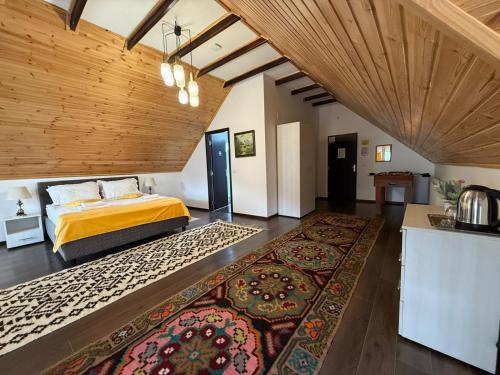 a bedroom with a bed and a large rug at Eisenau Luxury View in Prisaca Dornei