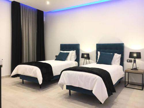 a room with two beds in a room at Villa Sunset View Tenerife, Simply Amazing in Adeje