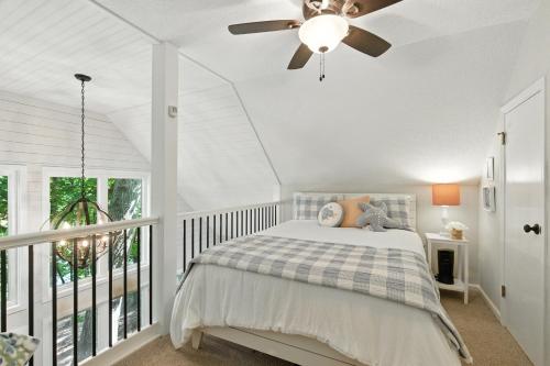 a bedroom with a bed and a ceiling fan at The Holiday House w Dock in Townville