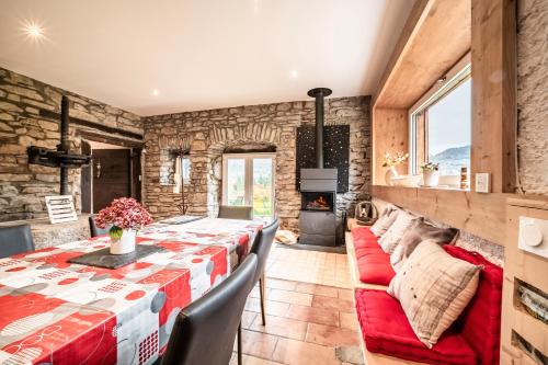 a dining room with a table and chairs and a fireplace at Les Gites Leyetaz in Châtillon-sur-Cluses