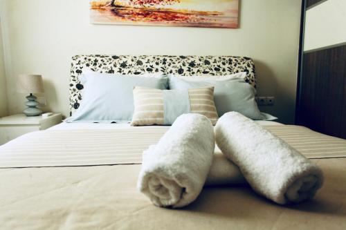 a bedroom with a bed with towels on it at The little palace next to the sea in Rethymno Town