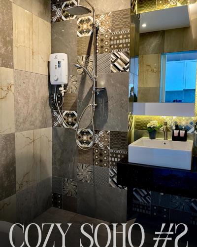 a bathroom with a shower and a sink in it at Cozy Soho #2 By TwoKeys in Miri