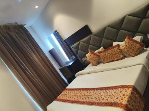 a bedroom with two beds and a window at AMRITSAR AVI INN 100 Meter from golden temple in Amritsar