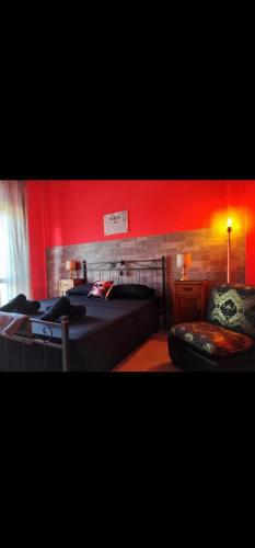a bedroom with two beds and a red wall at Hotel Transilvania 