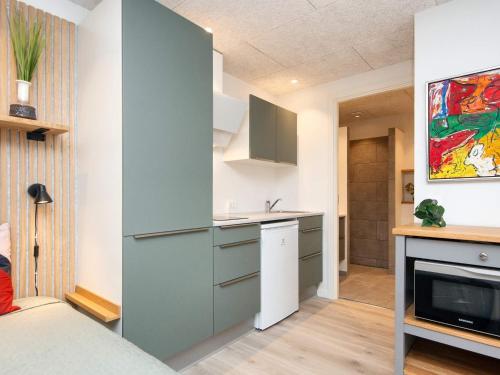 a kitchen with blue cabinets and a counter top at Søndervig Holiday Center in Ringkøbing