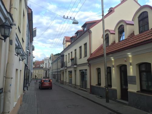 a car driving down a street with buildings at Apartments Satva in Vilnius