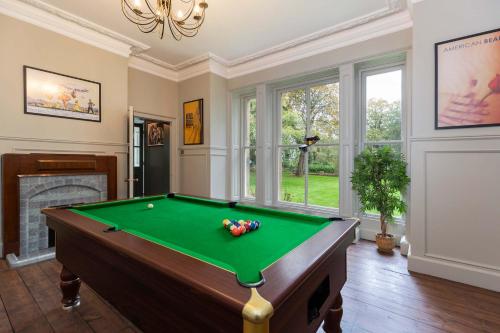 a living room with a pool table and a fireplace at The Vicarage in Billingham