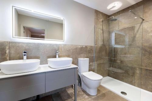 a bathroom with a sink and a toilet and a shower at The Vicarage in Billingham