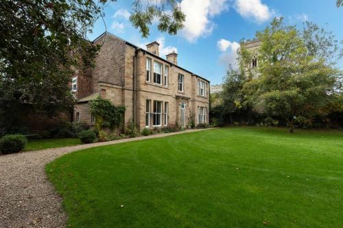 an old stone house with a large yard at The Vicarage in Stockton-on-Tees