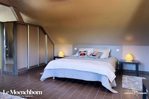 Un dormitorio con una cama con dos animales de peluche encima. en Le Moenchborn - la Maison des Vignerons, en Orschwiller