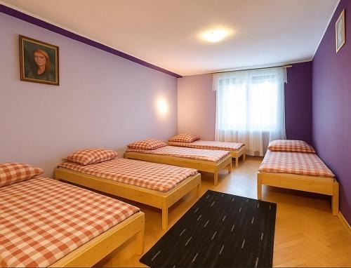 a room with four beds and a window at BIZAR Hostel in Sadowa