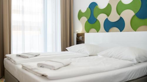 Postel nebo postele na pokoji v ubytování VacationClub - Baltic Park Molo Apartament D106