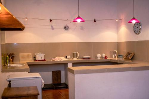 a kitchen with a counter and a clock on the wall at Calm Villa in Ahangama