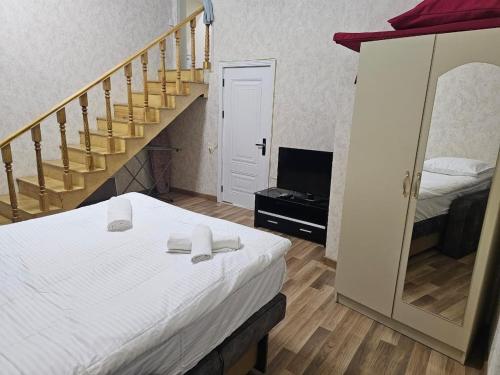 a bedroom with a bed and a staircase with a mirror at Nizami 37 in Baku