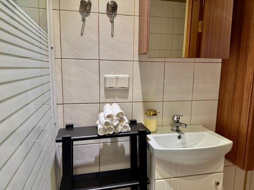 a small bathroom with a sink and a mirror at Pilies23 Old Town Luxury Apartment in Vilnius
