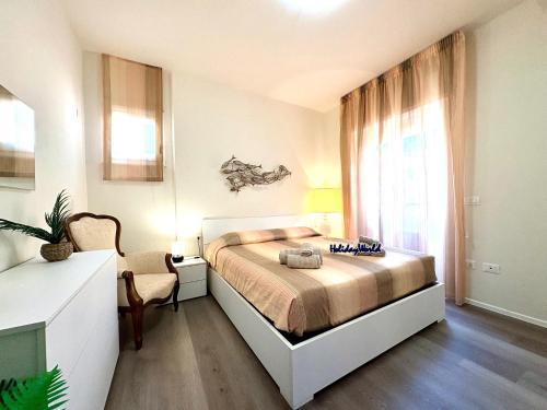 a bedroom with a bed and a large window at Stella Marina by Holiday World in Varazze
