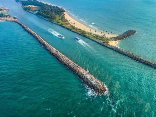 an aerial view of a beach with boats in the water at vks holiday homes in Malpe