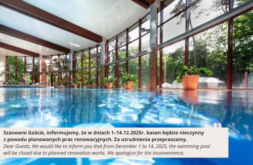 a picture of a swimming pool with windows at Hotel Dom Zdrojowy Resort & SPA - Destigo Hotels in Jastarnia