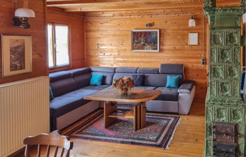 a living room with a couch and a table at Amazing Home In Podstene in Kupa