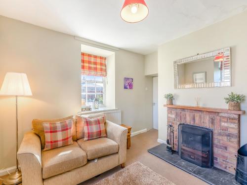 a living room with a couch and a fireplace at South Lodge - Uk48318 in Berwick-Upon-Tweed