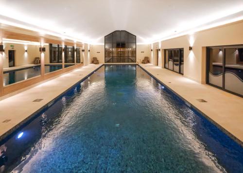 a swimming pool in a building with water in it at Knights Lodges in Newton Solney