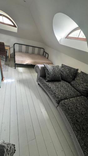 a living room with a couch and a bed at Sancta Katharina in Rozvadov