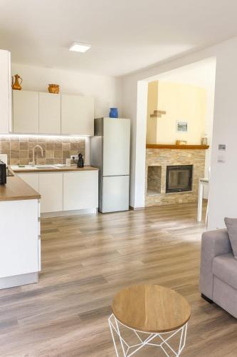 a kitchen and living room with a couch and a table at Casa Perla dei Laghi - Lake View, BBQ, WiFi 1Gb & AirCond in Porlezza