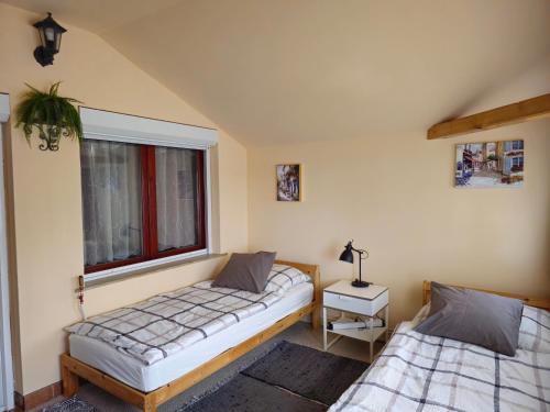 a bedroom with two beds and a window at Family Friendly Gyál in Gyál
