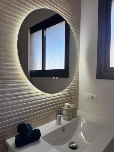 a bathroom with a mirror and a sink at Calma Mediterránea in Aguadulce