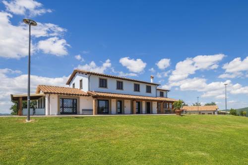 a large house with a green lawn in front of it at Villa Setona by VacaVilla in Bucine