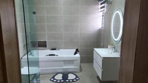 a bathroom with a sink and a mirror at MM Luxury 3 bedroom Duplex Terrance in Aja