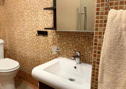 a bathroom with a sink and a toilet at High Altitude Makkah - Aziziya Spacious Flat in Makkah