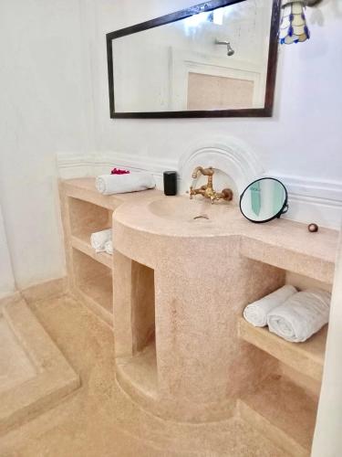 a bathroom with a sink and a mirror at Baytulkher in Lamu