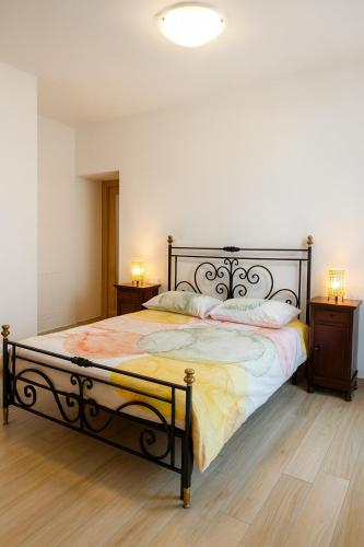 a bedroom with a large bed with two night stands at Borgo nel Vigneto 1 in Erbusco
