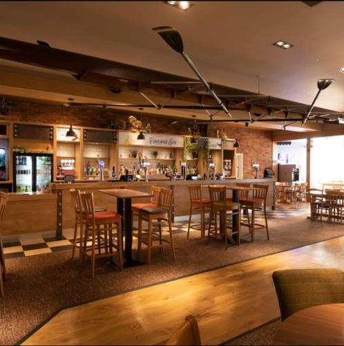 a restaurant with tables and chairs and a bar at Fabulous seaside caravan getway at Cayton Bay in Scarborough
