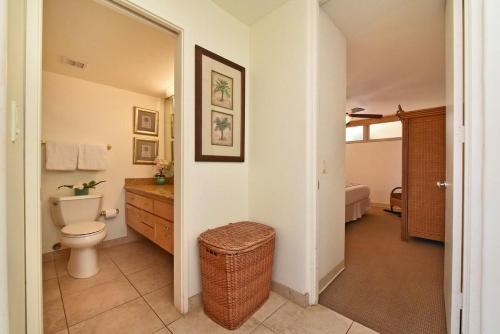 a bathroom with a toilet and a sink at Kahana Reef 117 · KR 117 Renovated OceanFront 1BD w Ocean Views in Kahana