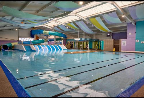 a large swimming pool with a water slide at Fabulous seaside caravan getway at Cayton Bay in Scarborough