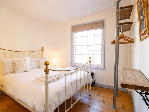 a bedroom with a bed and a window at Easter Cottage - Central Rye Effortless Chic Pass the Keys in Rye