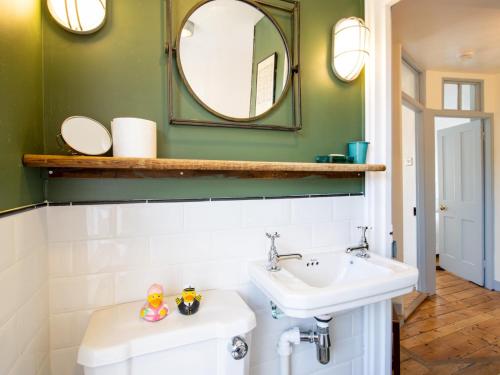 a bathroom with a sink and a mirror at Easter Cottage - Central Rye Effortless Chic Pass the Keys in Rye