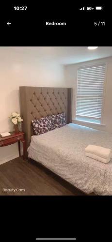 a bedroom with a large bed with a window at Sweet and beautiful bedroom in Baltimore