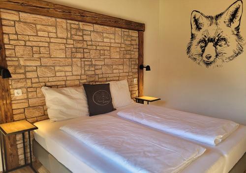 a bedroom with a bed with a wolf head on the wall at Pension Leano in Nötsch