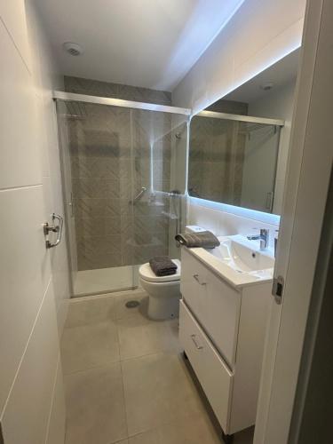a bathroom with a shower and a toilet and a sink at LM APARTAMENTOS Aguacate Costa Tropical in Motril