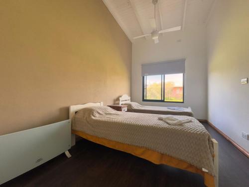 a bedroom with a bed and a window at El Renacer Duggan in Duggan