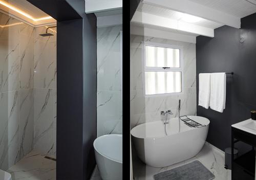 a bathroom with a tub and a toilet and a sink at 1 bedroom cottage south of Cape Town in Marina Da Gama